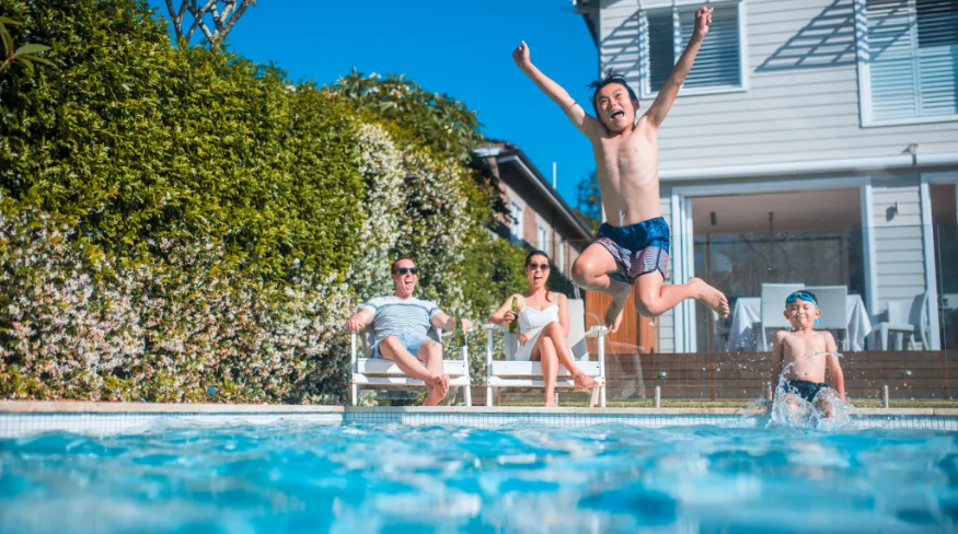 Family having fun in the backyard pool.