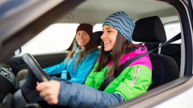 Women driving her car in the winter.