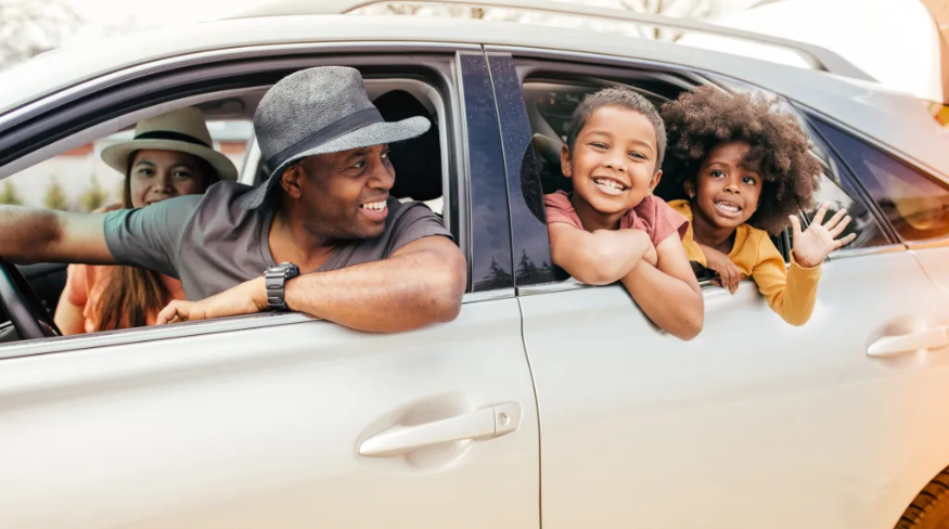 Happy family driving in their car.