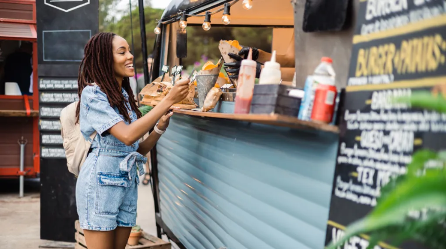Women ordering food at a food truck.