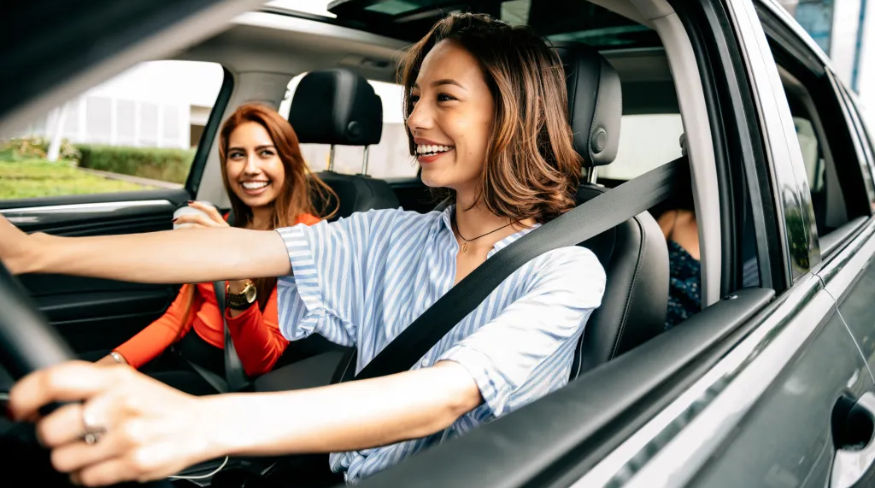Woman driving with a friend.