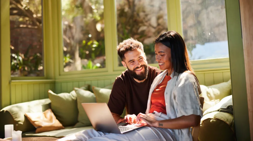Young couple working on a laptop together.