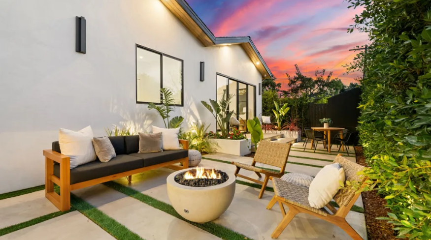 Modern outdoor patio with cozy seating and fire pit.