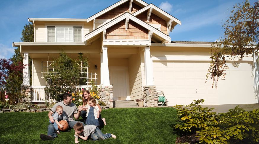 Family playing in the front yard of their house.