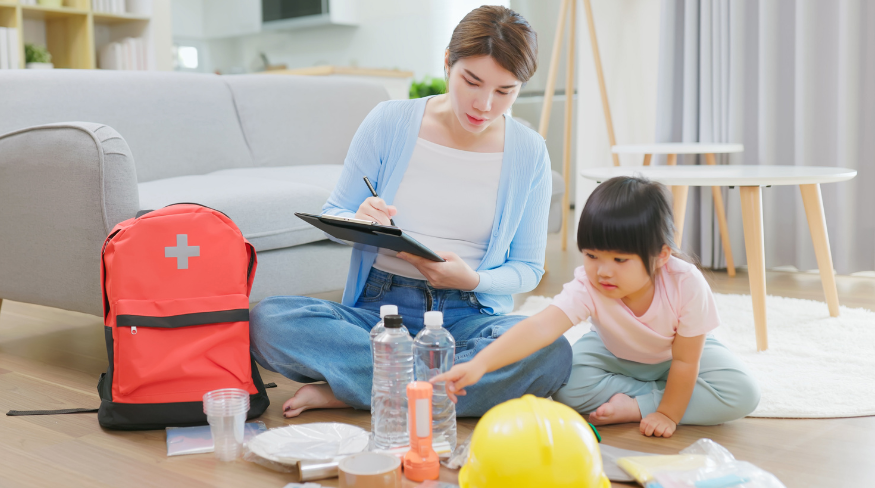 Mother and child preparing kit for emergencies.