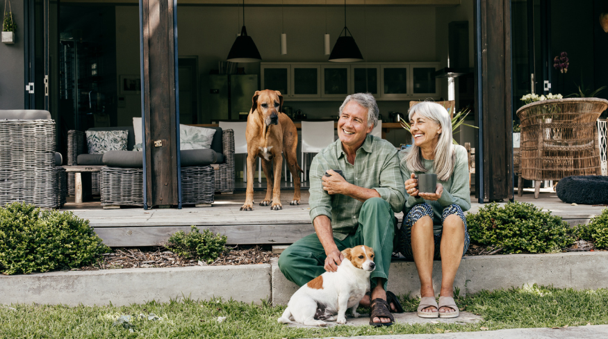 Happy couple sitting on their front porch.